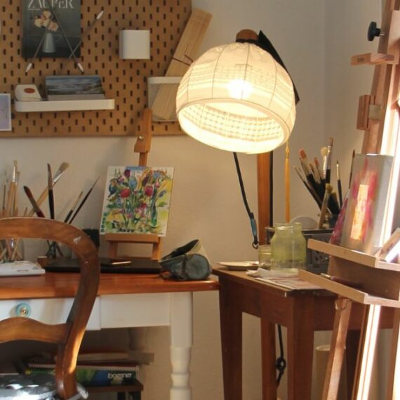 an eco-friendly art studio with a desk and easel