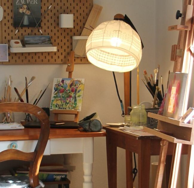 an eco-friendly art studio with a desk and easel