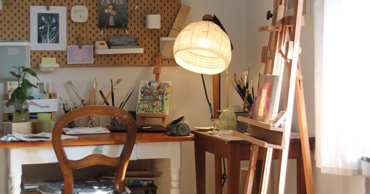 an eco-friendly art studio with a desk and easel