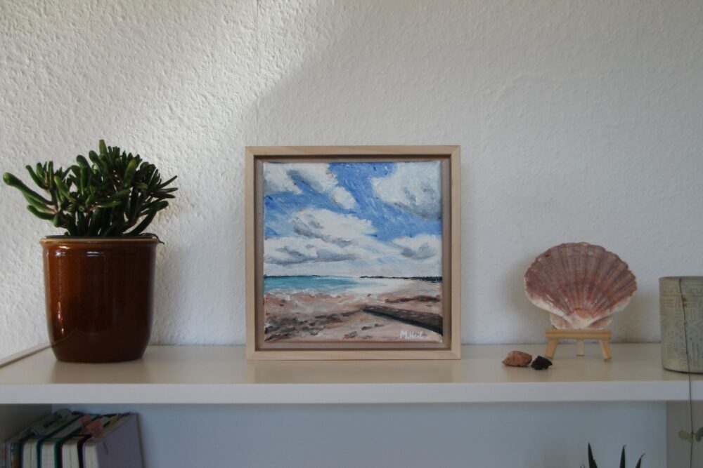 Beach view oil painting on bookshelf