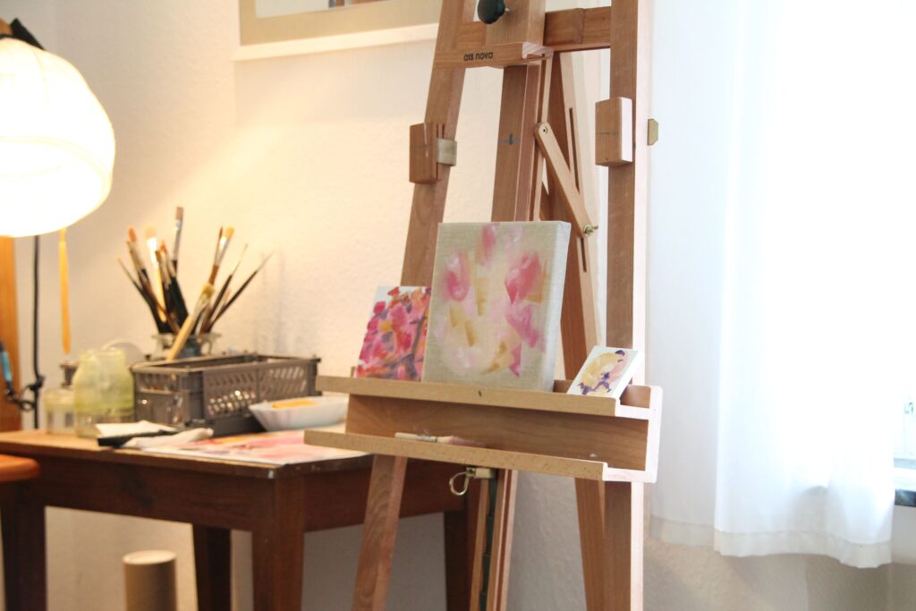 an easel for oil painting showing abstract artworks 