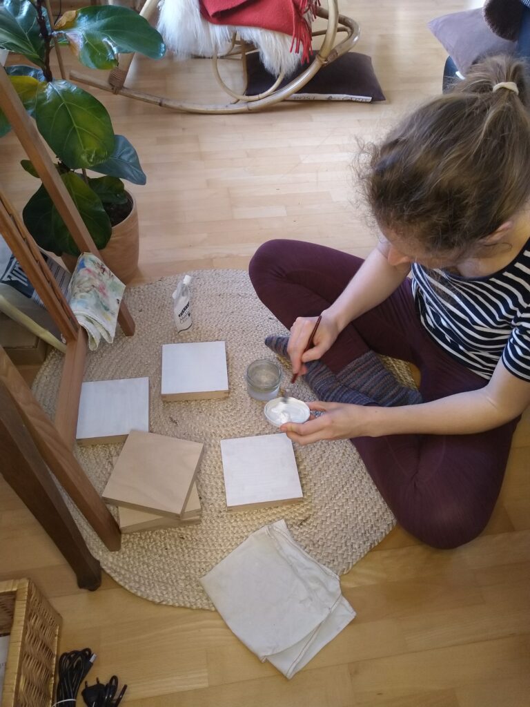 applying gesso to the wood panels for my spring flower paintings